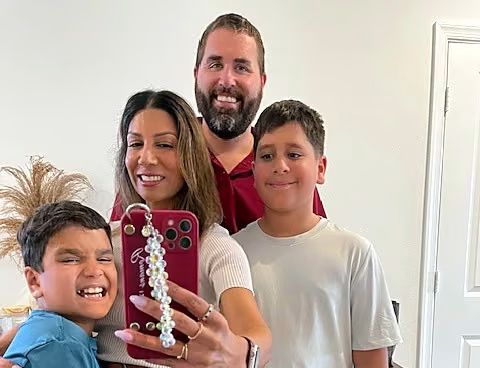 A smiling family of four at home